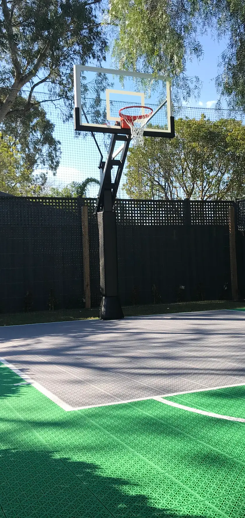 An Outdoor Sport Courts court shown at full size in a backyard through phone AR