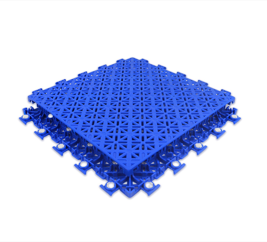 A single Outdoor Sport Courts interlocking sport-court tile — open anti-slip lattice top with silicon cushion feet underneath